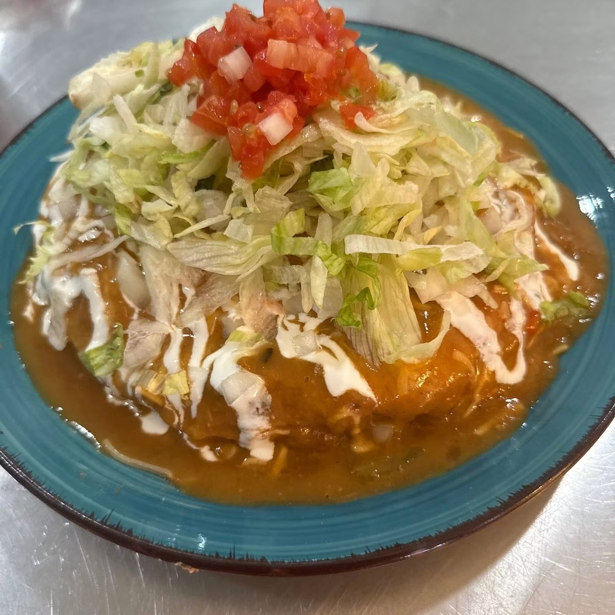 Stuffed sopapilla smothered in green chili
