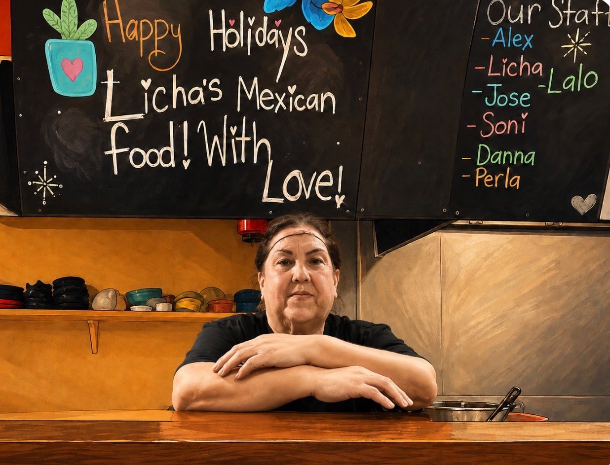 Licha at the counter of the kitchen, standing in front of a chalkboard reading Licha's Mexican Food! With Love!
